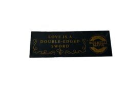 Black and gold sticker: LOVE IS A DOUBLE-EDGED SWORD with BORRELLI MAZA logo.